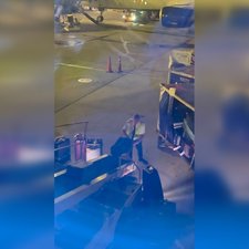 delta air lines pilot helping bags